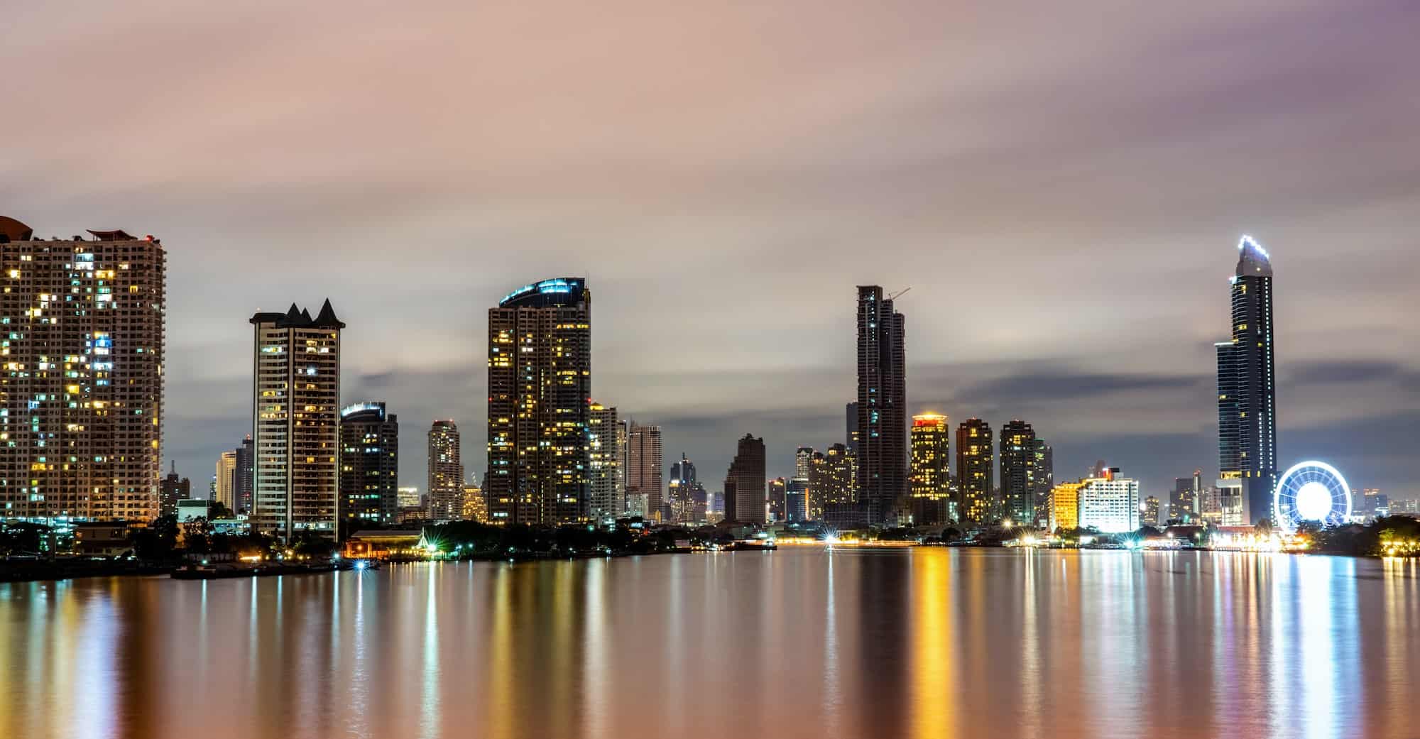 Cityscape of modern building near the river in the night. Modern architecture office building.