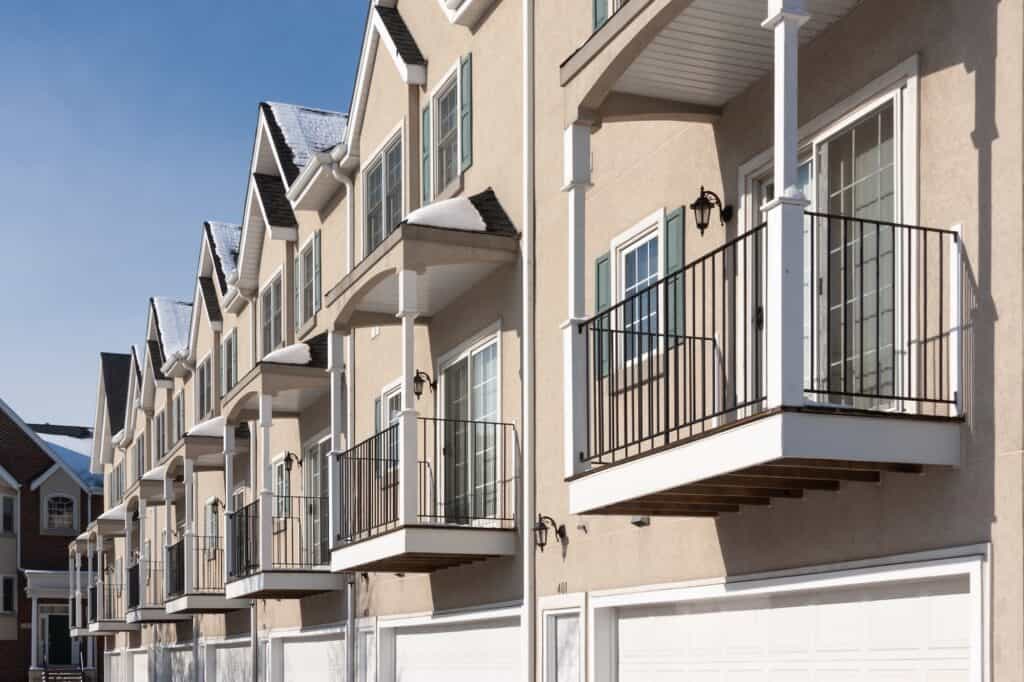 Row of Apartment Condominiums Balconies and Garage Doors.